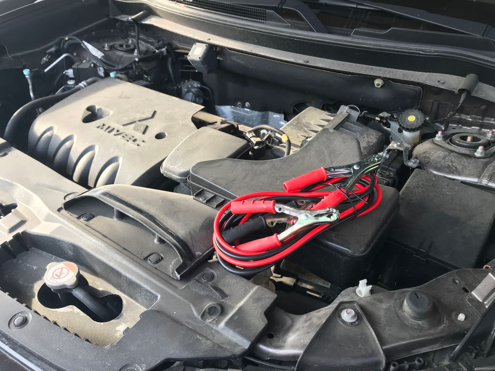 Jumper cables attached to a car battery