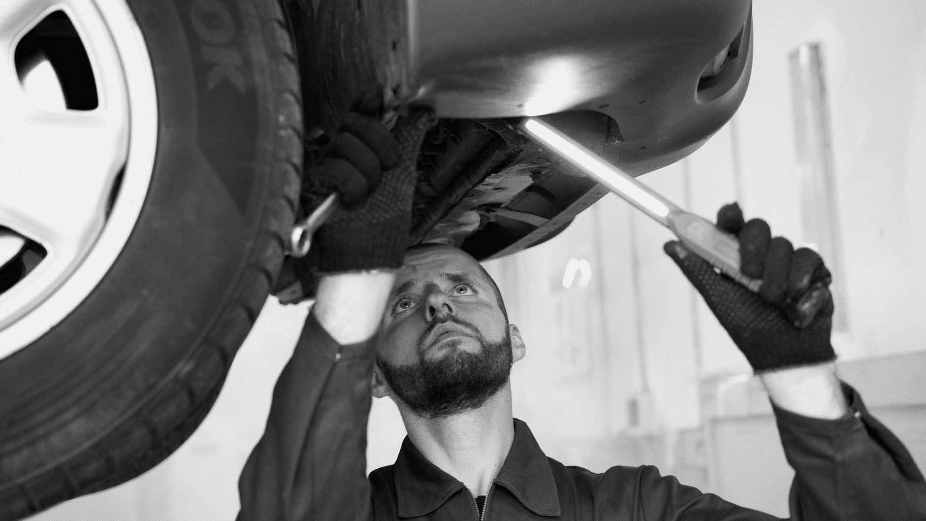 Mechanic changing a flat tire on the side of the road
