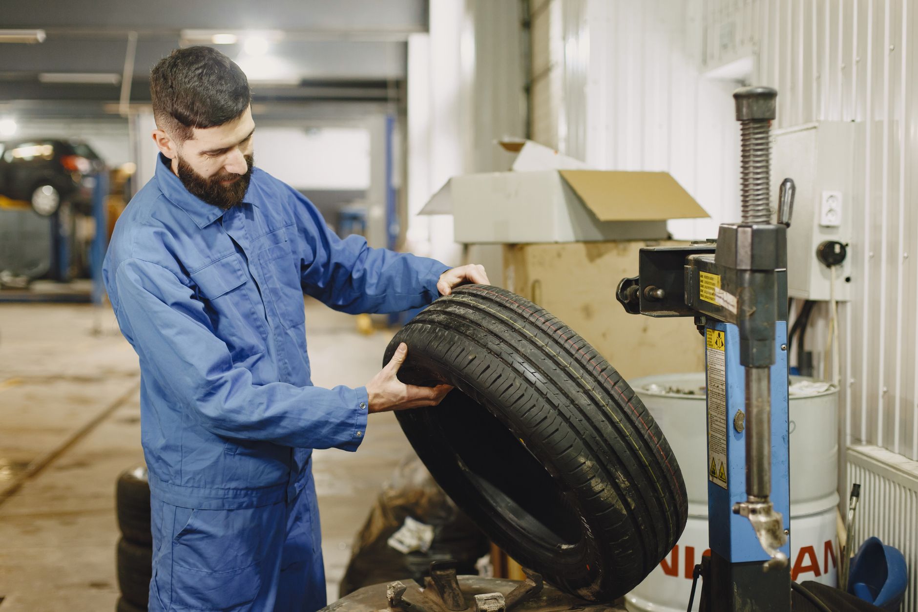Mechanic examining a tire in an automotive garage