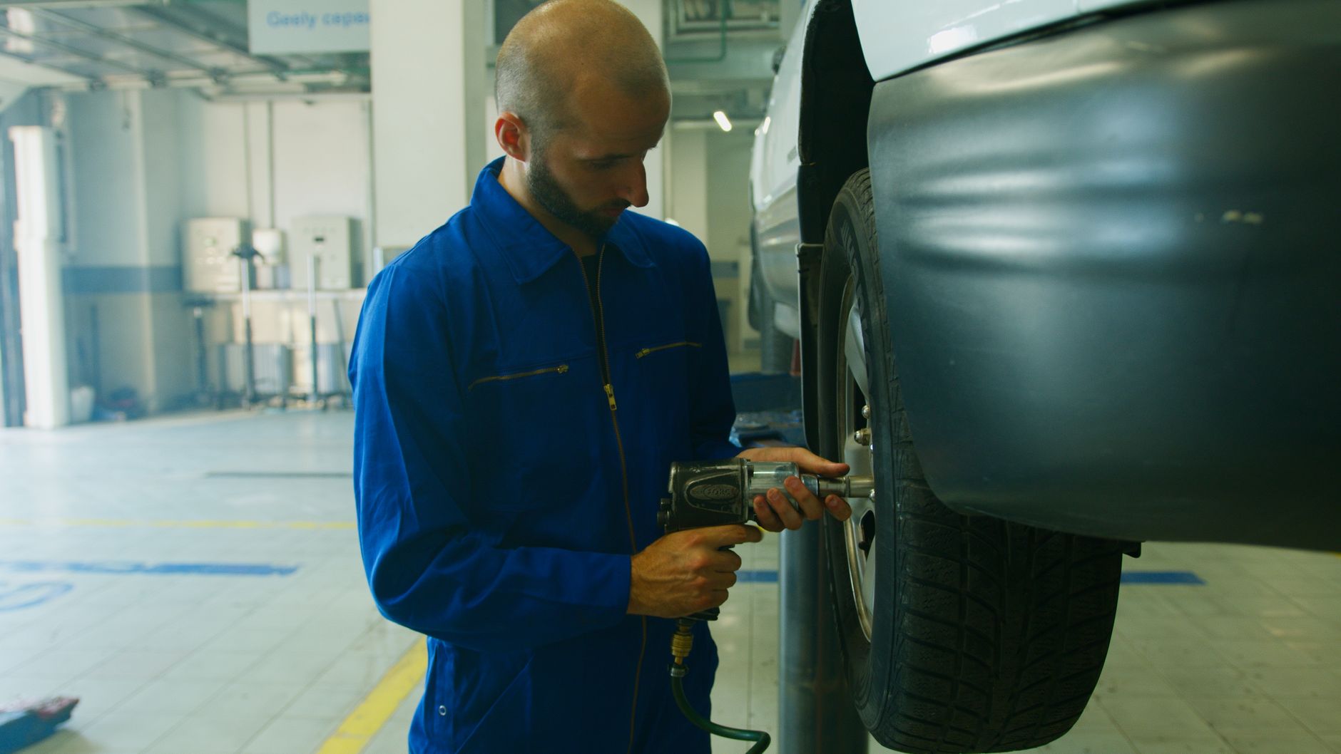 Professional mechanic repairing a tire