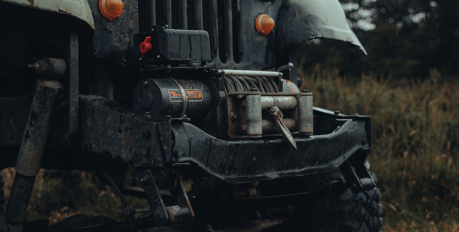 Tow truck winch pulling a car out of mud