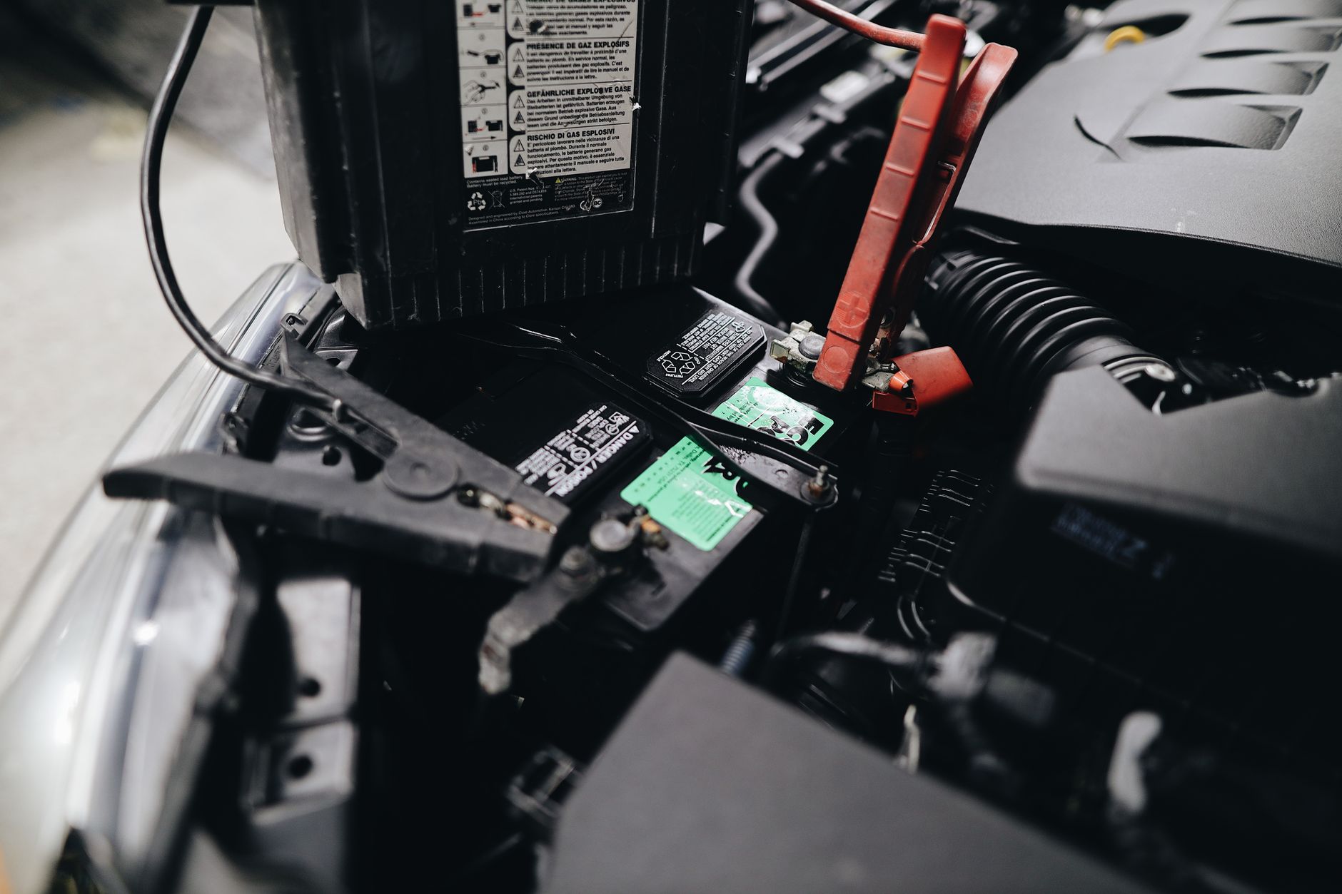 Mechanic jump starting a car