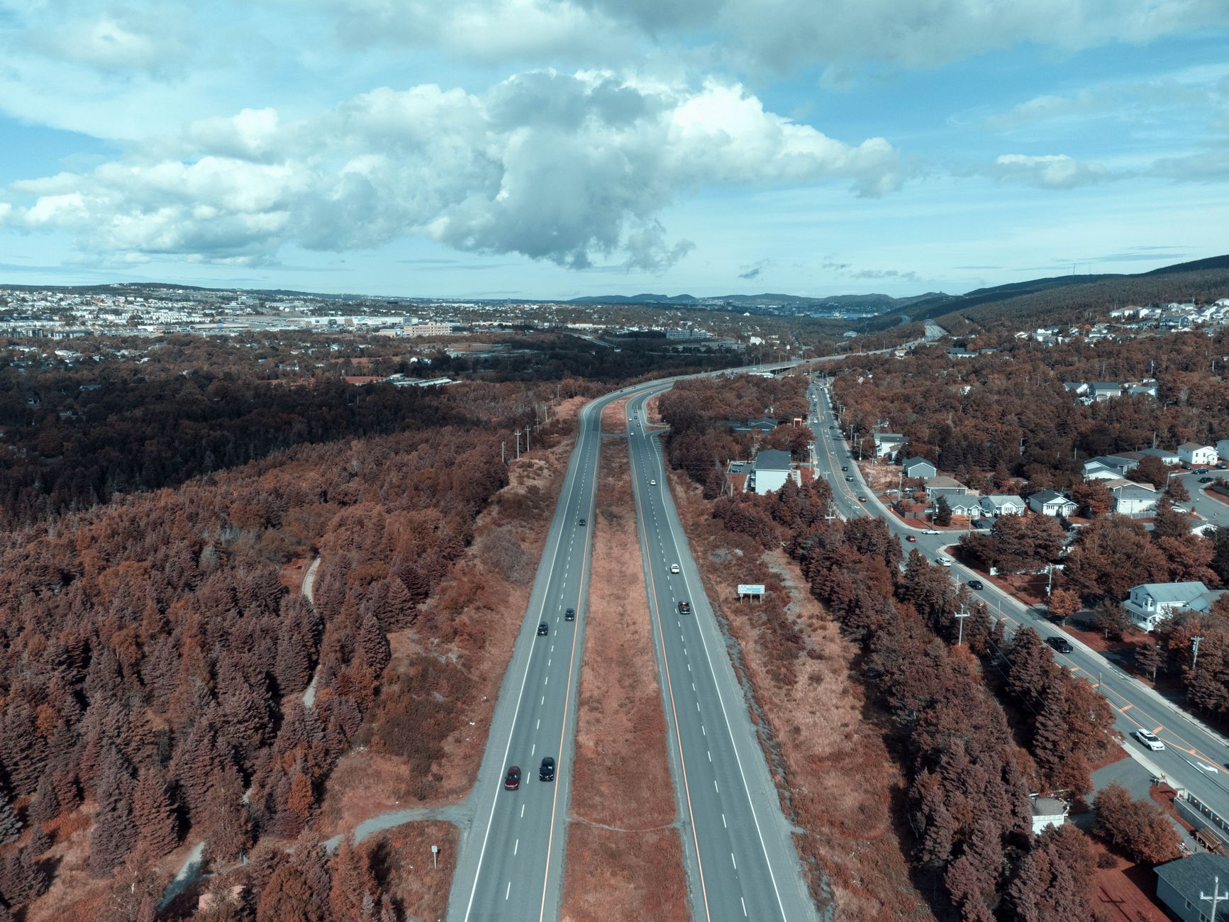 Aerial view of a highway cutting through rural landscape