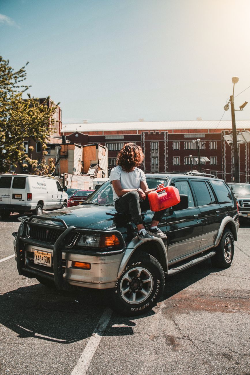 Person holding a red gas can