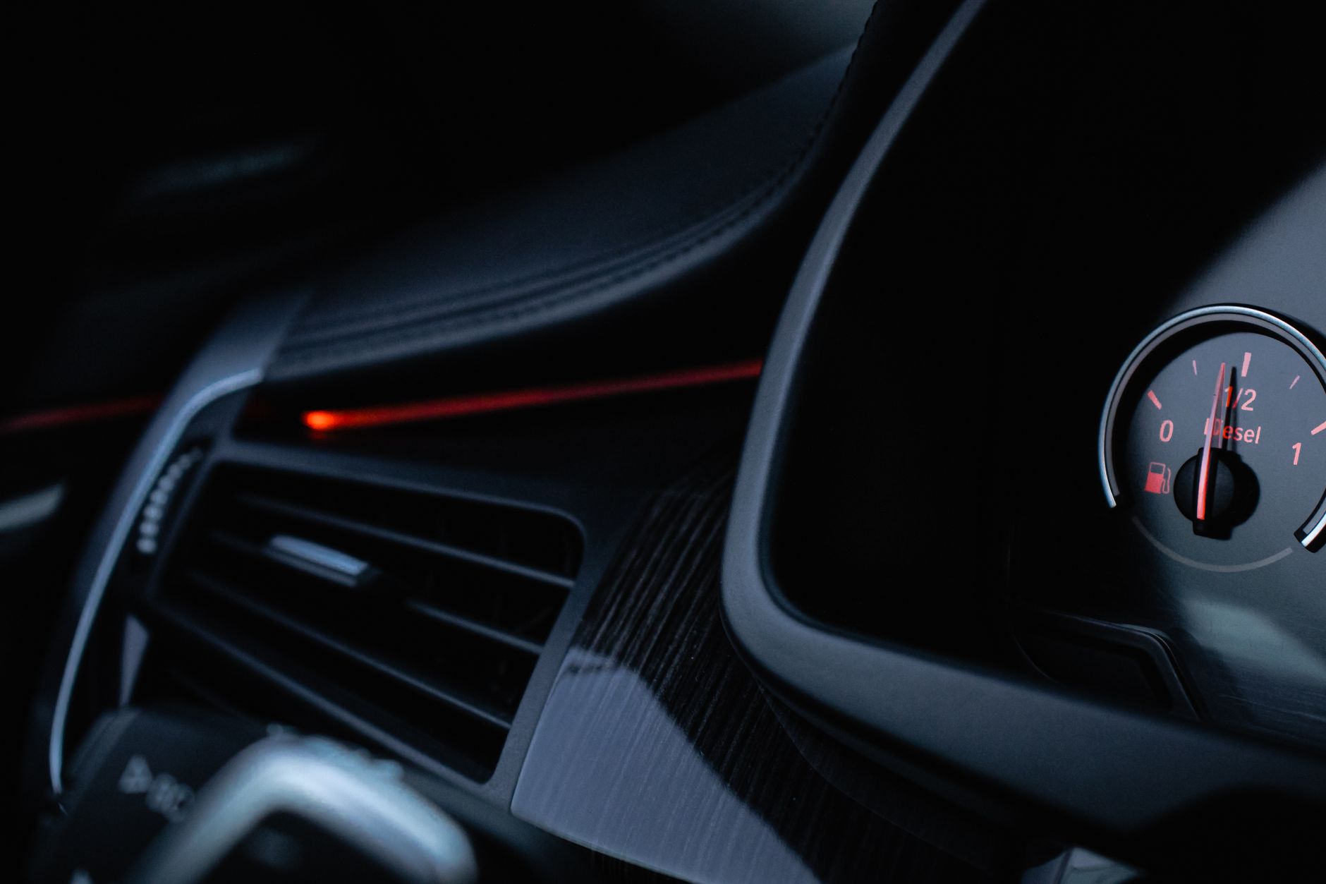 Car fuel gauge pointing to empty