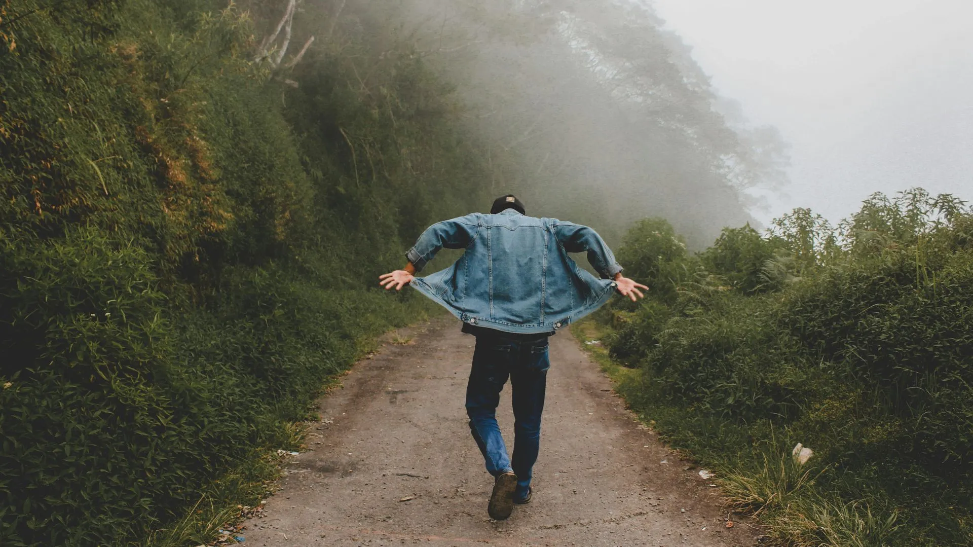 Man walking down a dirt road