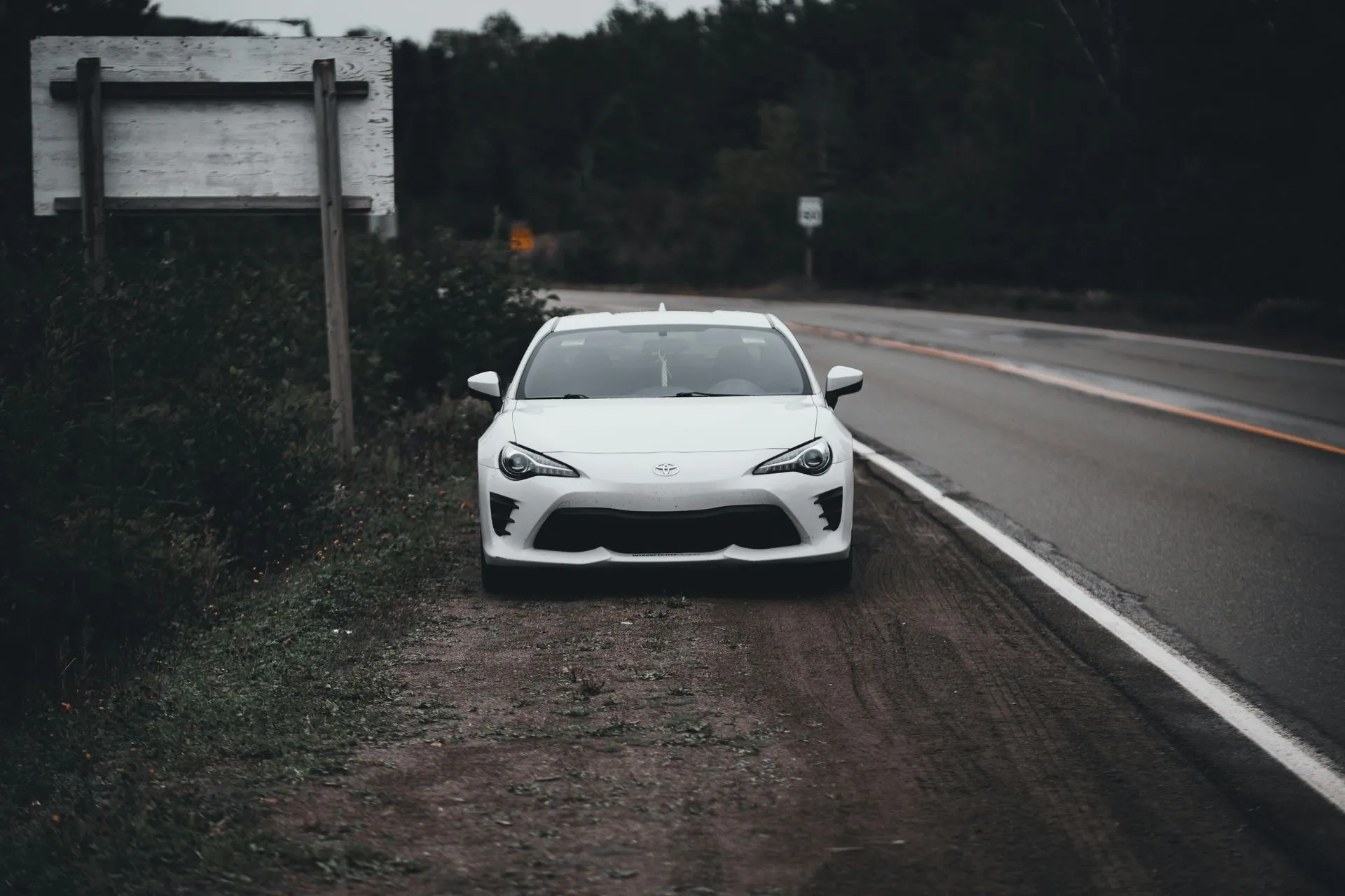 White car parked on the side of the road