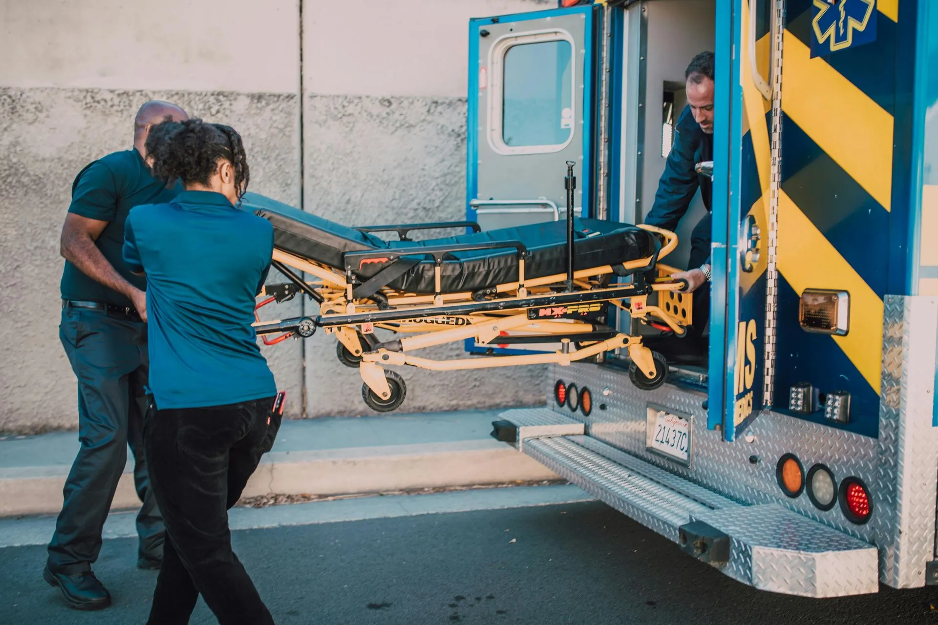 Paramedics pushing a stretcher, symbolizing emergency readiness